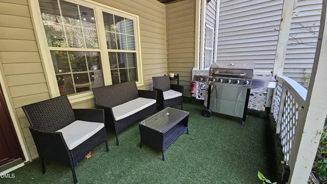 a view of a chairs and table in back yard of the house