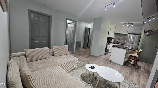 a bedroom with furniture and a chandelier
