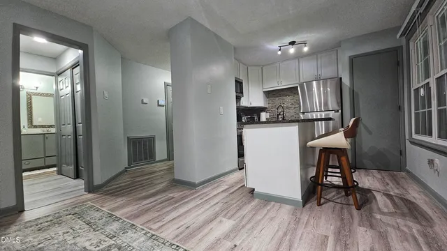 a kitchen with stainless steel appliances a refrigerator and a stove top oven