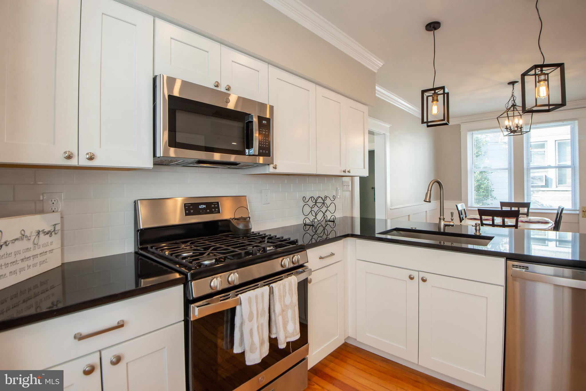 3323 Rueckert Avenue Baltimore, MD 21214 - Photo 6 of 27 SS appliances, granite countertop pendant lights