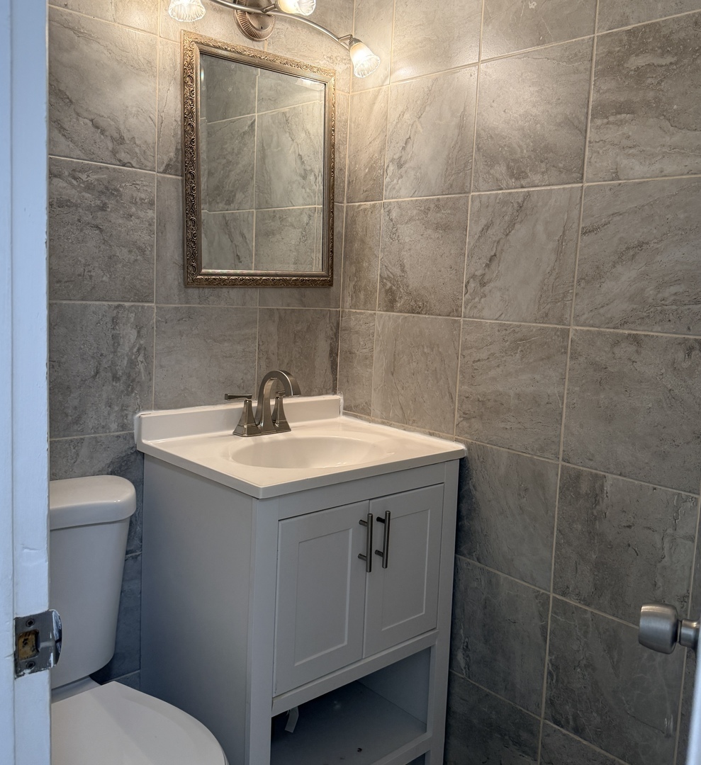 533 Redwood Road Bolingbrook, IL 60440 - Photo 14 of 18 a bathroom with a sink toilet and a mirror