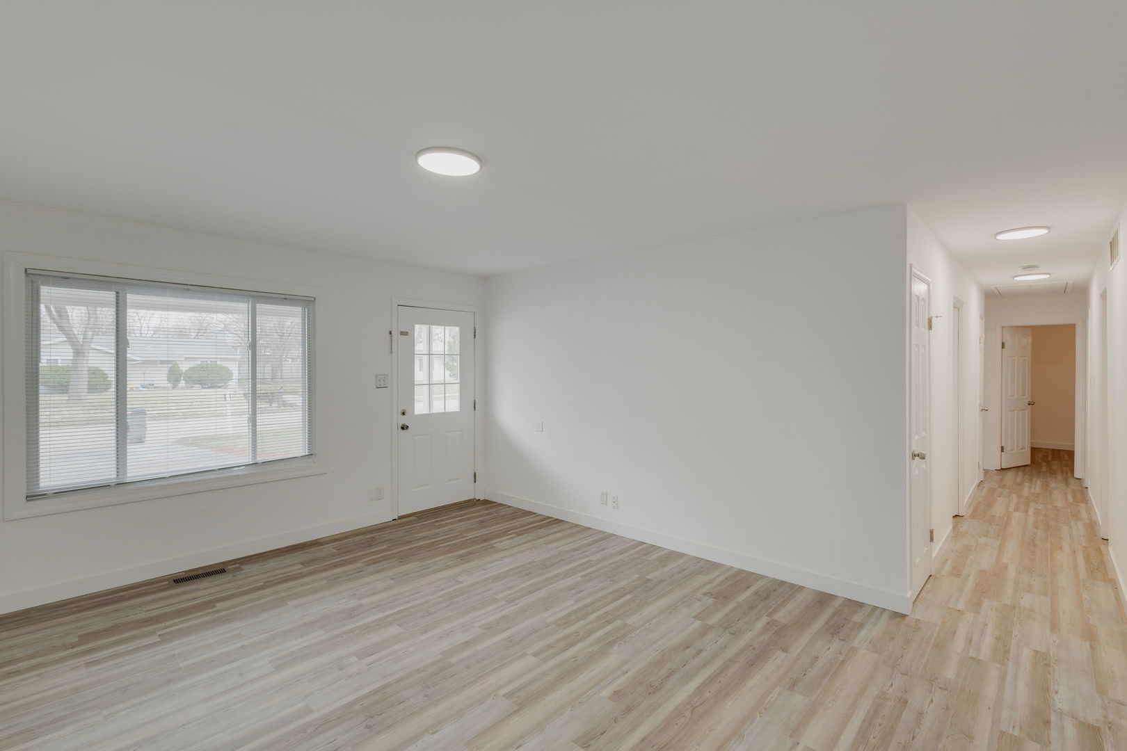 533 Redwood Road Bolingbrook, IL 60440 - Photo 4 of 18 an empty room with wooden floor and windows
