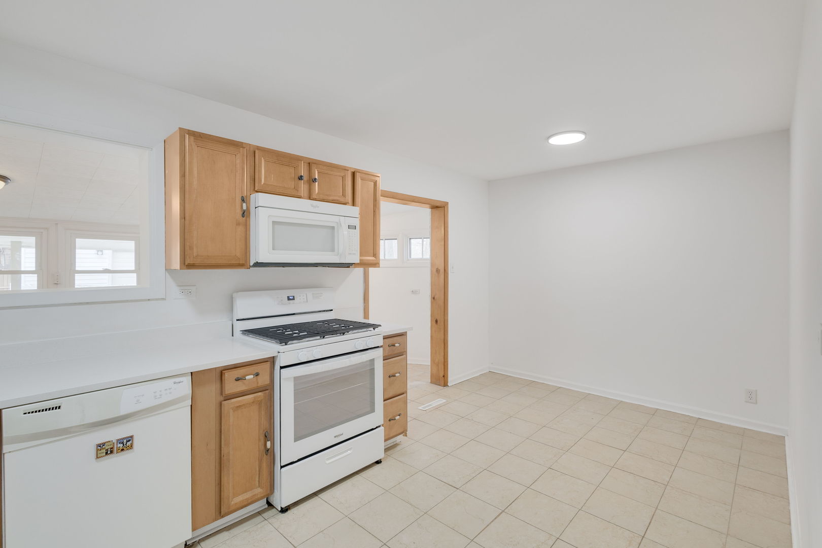 533 Redwood Road Bolingbrook, IL 60440 - Photo 6 of 18 a kitchen with white cabinets and white appliances