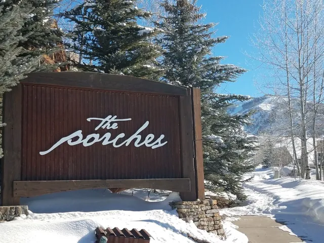 a view of a wooden fence and a tree
