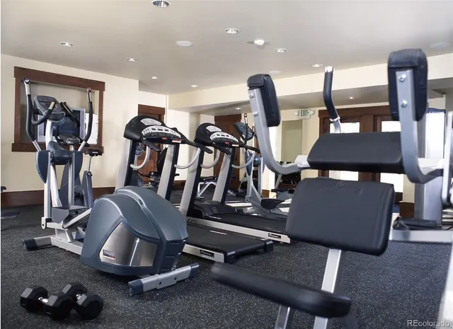 a room with gym equipment and view of living room