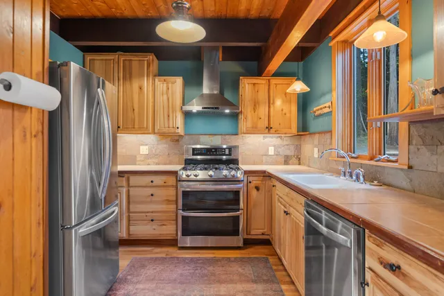 a kitchen with a sink stove and refrigerator