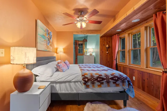 a bedroom with a bed and window