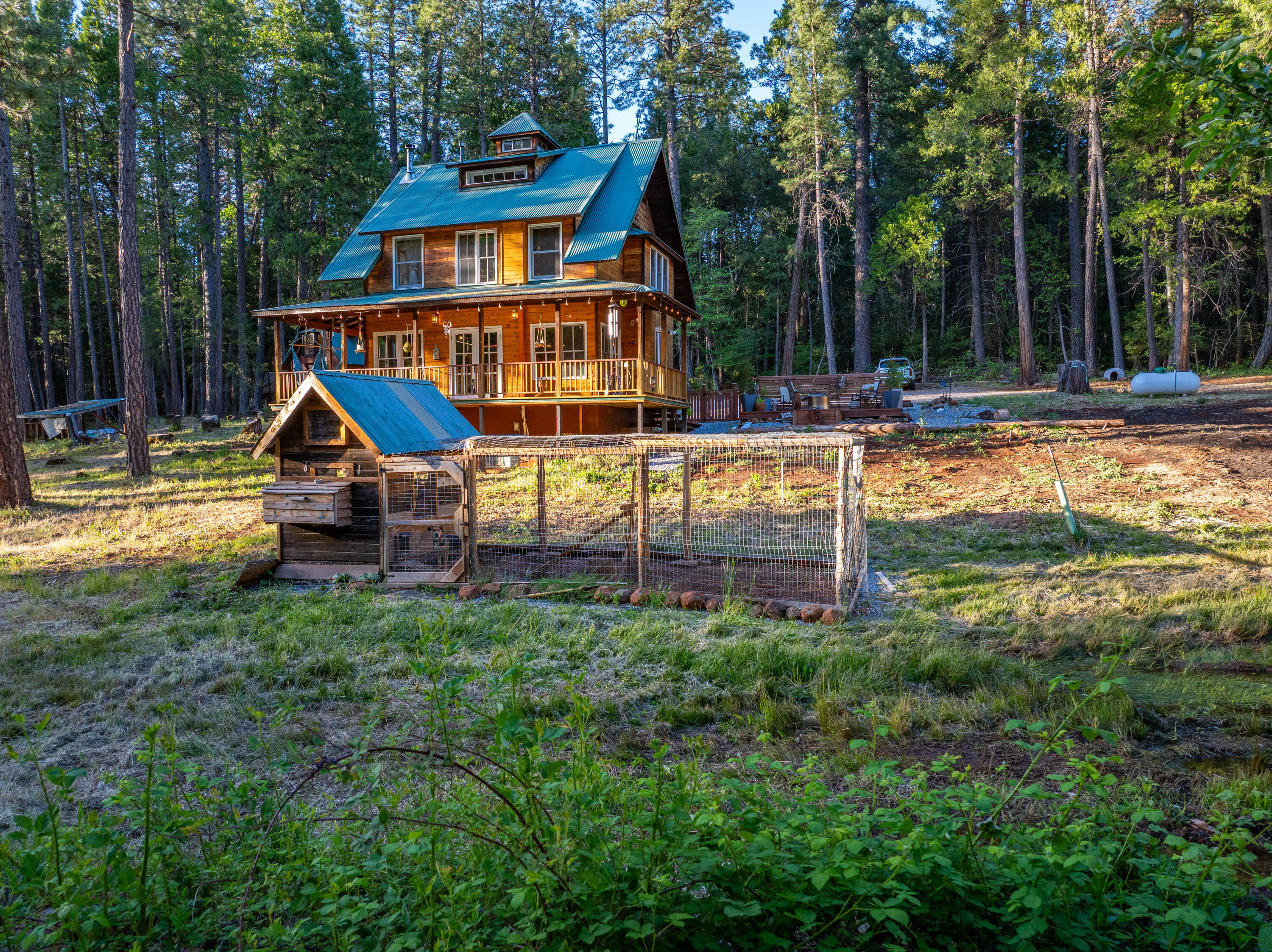 7704 Eastmoore Road Shingletown, CA 96088 - Photo 23 of 30 a view of a house with backyard and sitting area