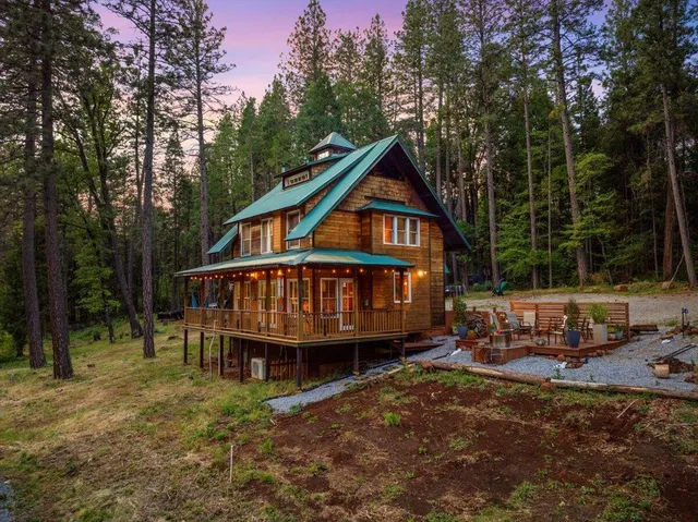 a view of a patio with a dining table and chairs and a barbeque