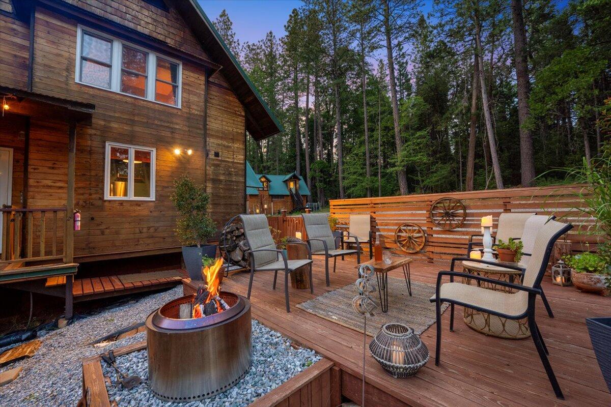 7704 Eastmoore Road Shingletown, CA 96088 - Photo 29 of 30 a view of a patio with a dining table and chairs and a barbeque