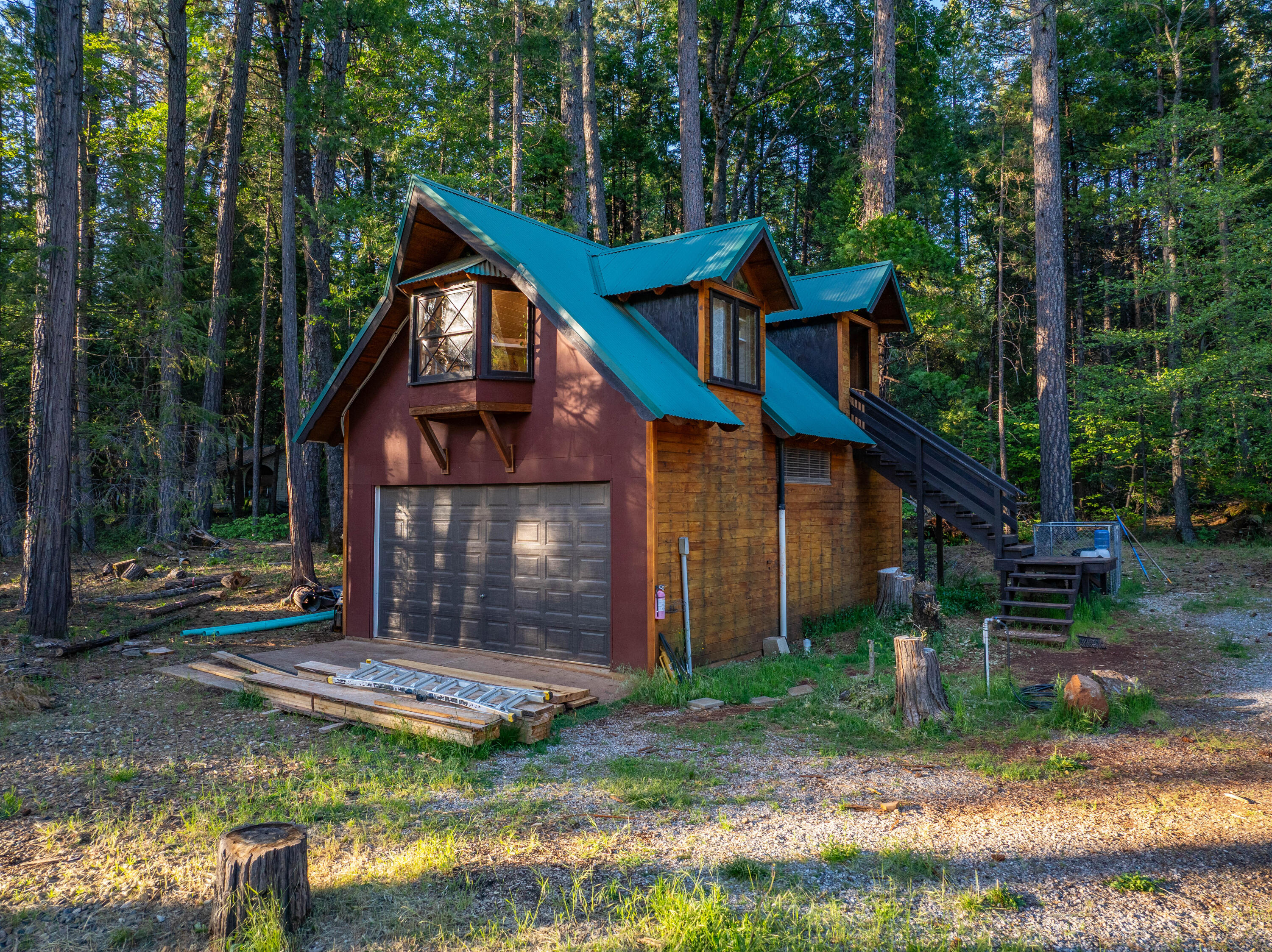 7704 Eastmoore Road Shingletown, CA 96088 - Photo 4 of 30 a front view of a house with garden