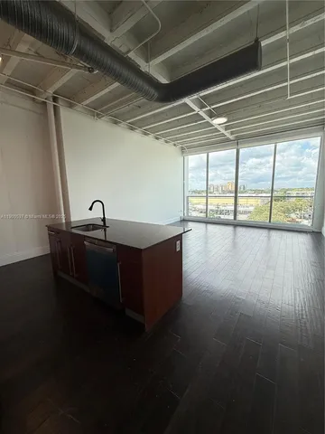 a view of a room with wooden floor