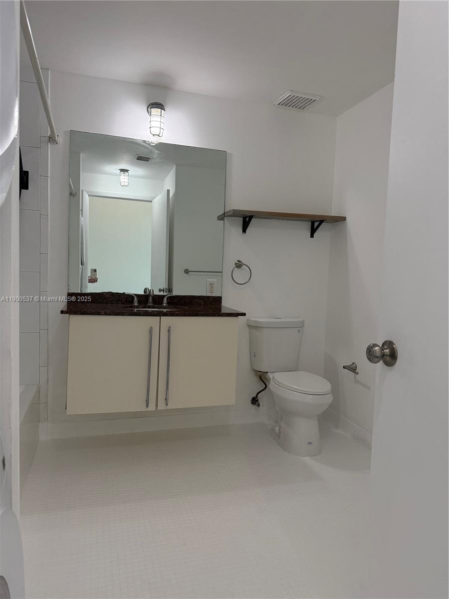 8101 Biscayne Boulevard, Unit R514 Miami, FL 33138 - Photo 8 of 11 a bathroom with a toilet