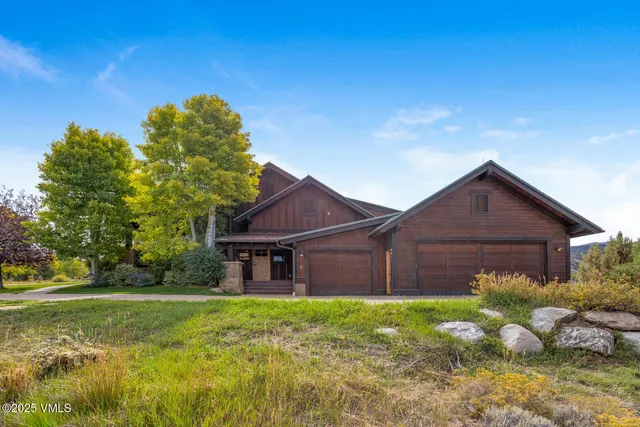 a view of a balcony with wooden chairs and floor to ceiling window