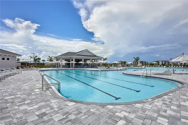a view of a swimming pool with outdoor seating