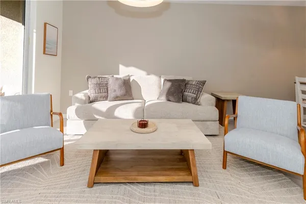 a living room with furniture and a rug