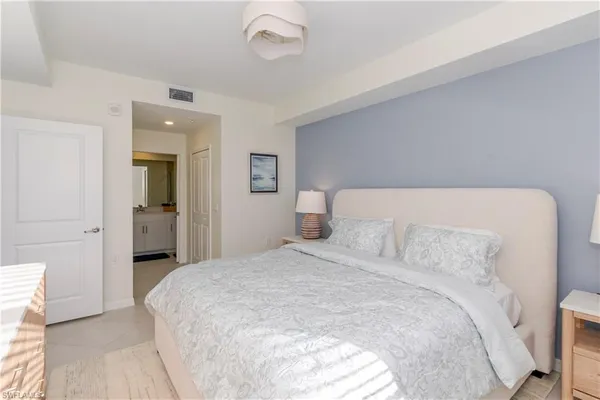 a bedroom with a bed and a mirror