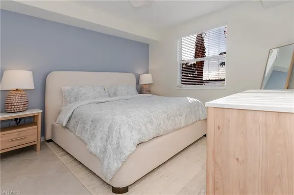 a bedroom with a bed and a night stand