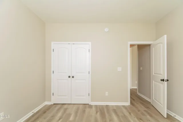 an empty room with closet area