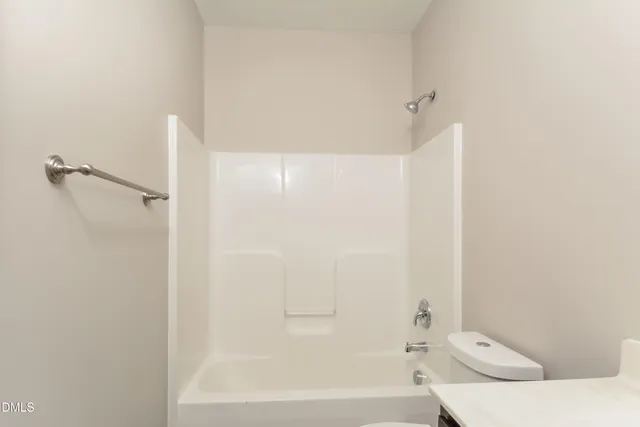 a bathroom with a bathtub and a toilet