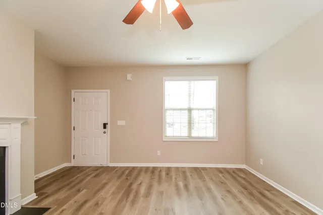 wooden floor in an empty room with a window