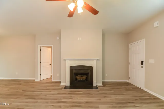 a view of a livingroom with a fireplace and window