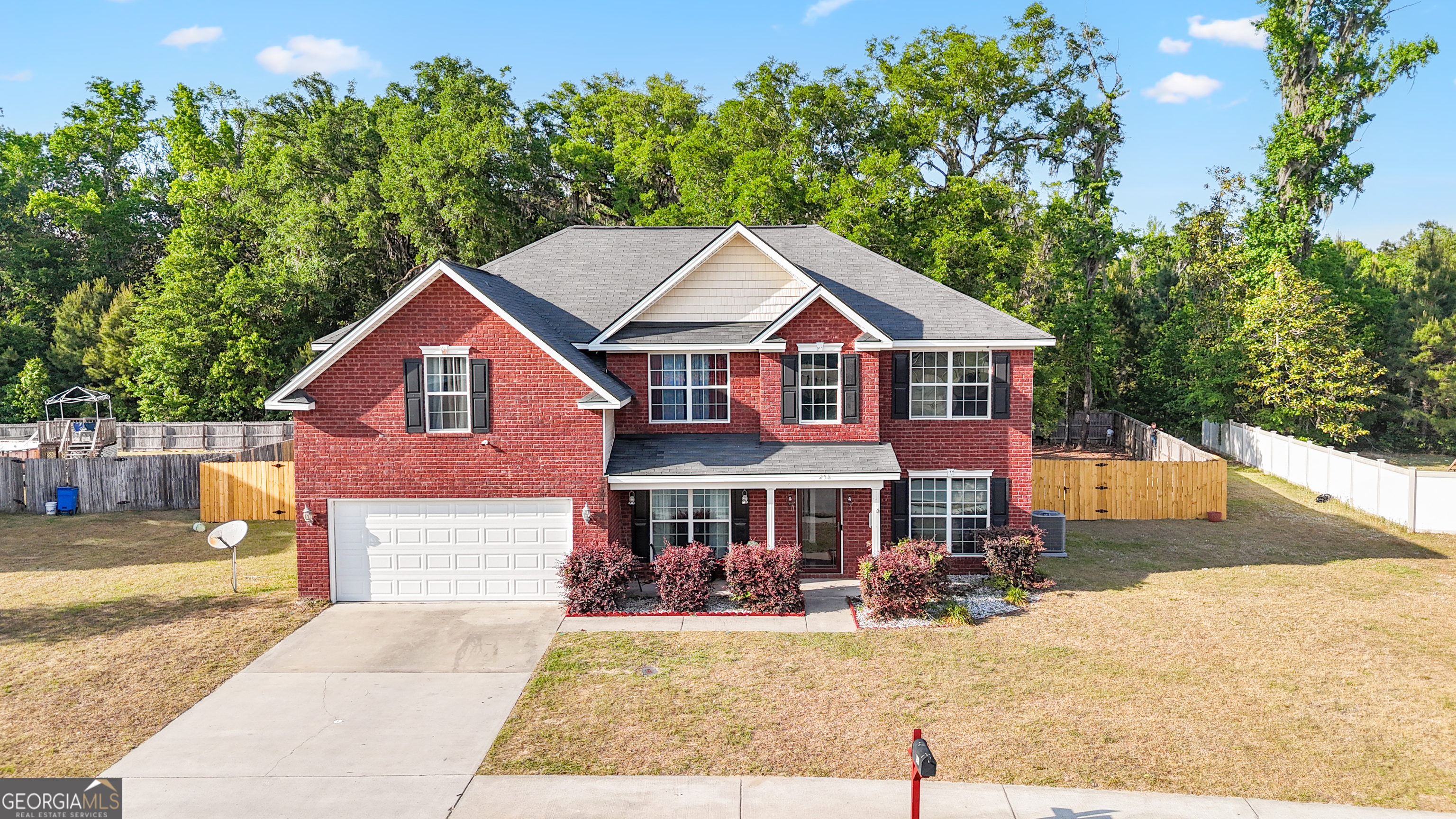 258 Nashview Trail Allenhurst, GA 31301 - Photo 1 of 40 a front view of a house with yard porch and tree