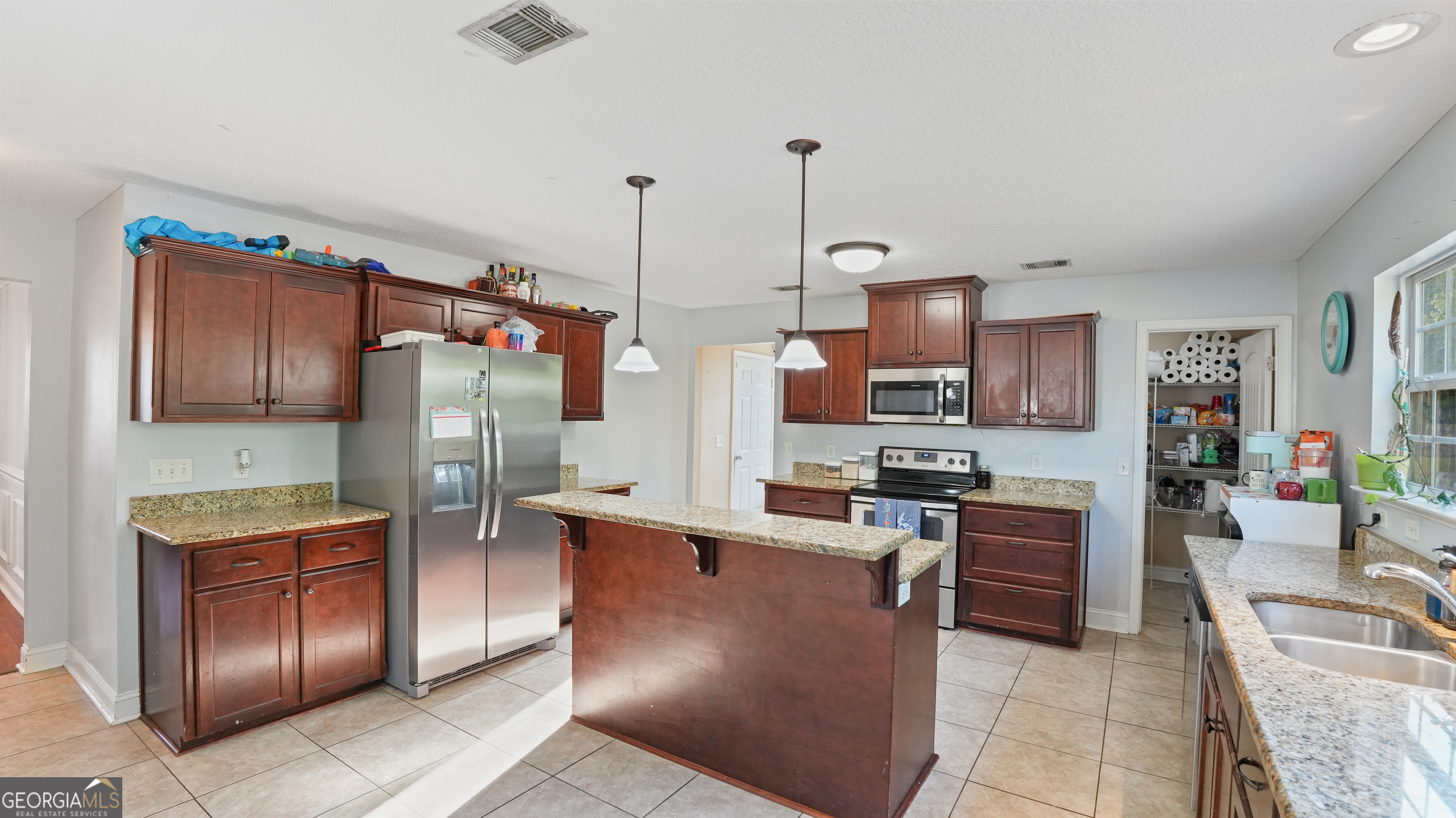 258 Nashview Trail Allenhurst, GA 31301 - Photo 17 of 40 a kitchen with stainless steel appliances granite countertop a refrigerator a stove and a sink