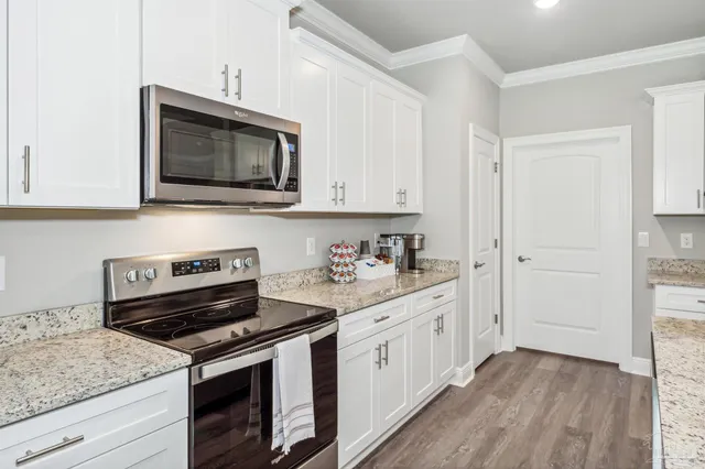 a kitchen with a stove and a microwave