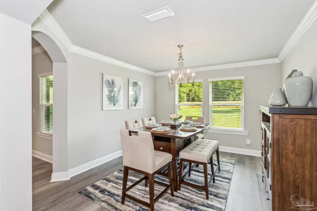 a dining room with furniture and window