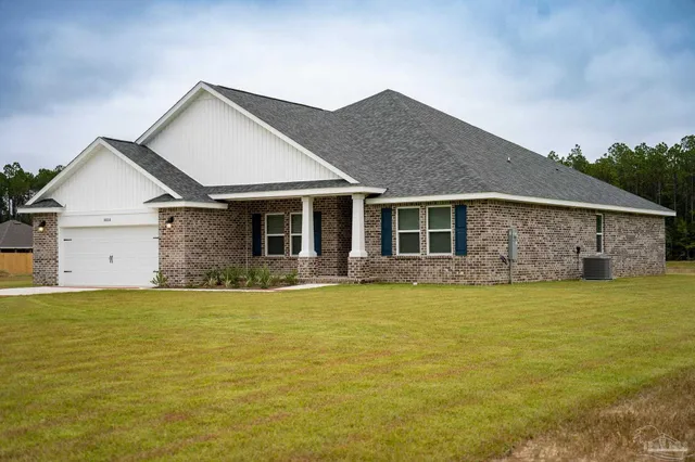 a front view of the house with a yard