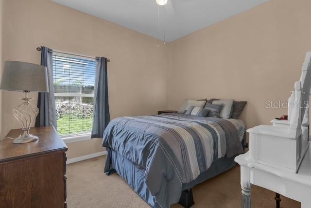 5120 Shale Ridge Trail Orlando, FL 32818 - Photo 13 of 15 a bedroom with a bed and a window