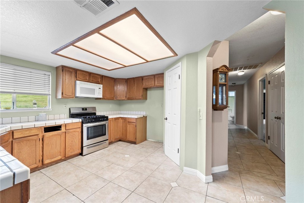 6770 Sandy Lane Riverside, CA 92505 - Photo 12 of 28 a kitchen with stainless steel appliances granite countertop a refrigerator and a sink