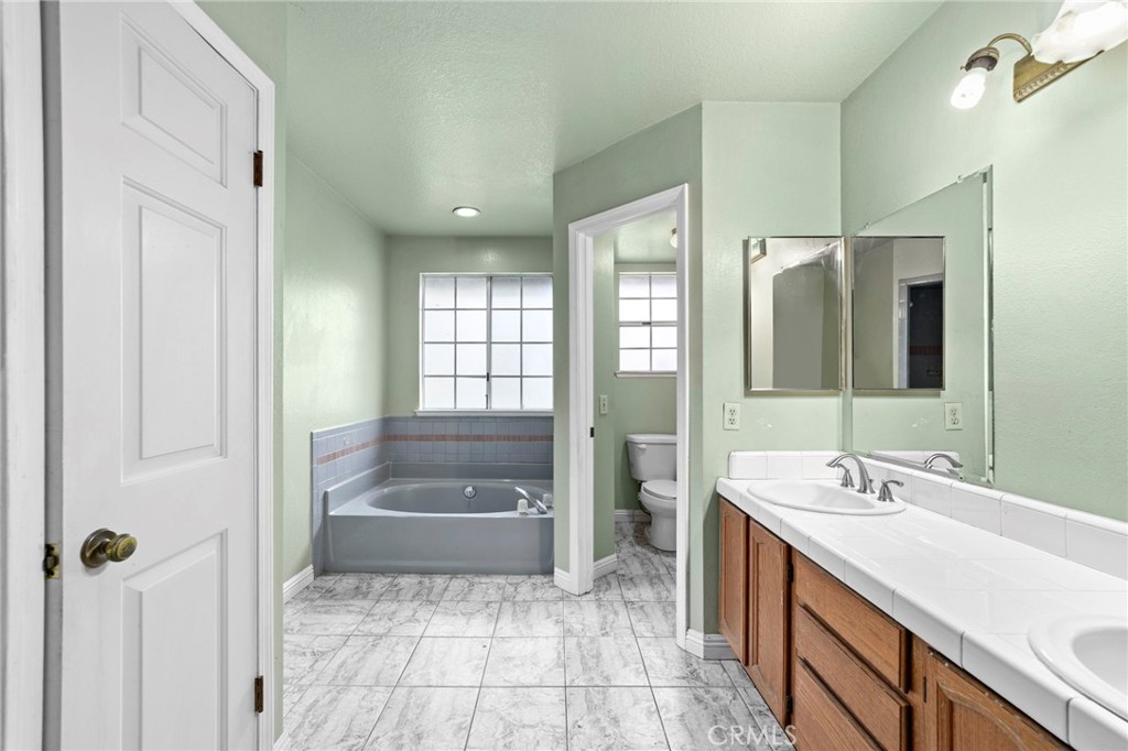 6770 Sandy Lane Riverside, CA 92505 - Photo 18 of 28 a bathroom with a sink a toilet and shower