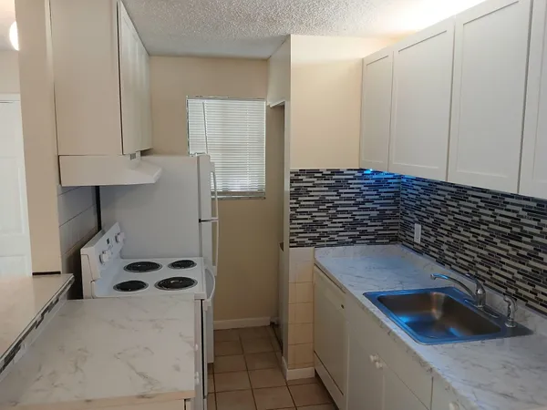 a view of a room with an empty space and a window