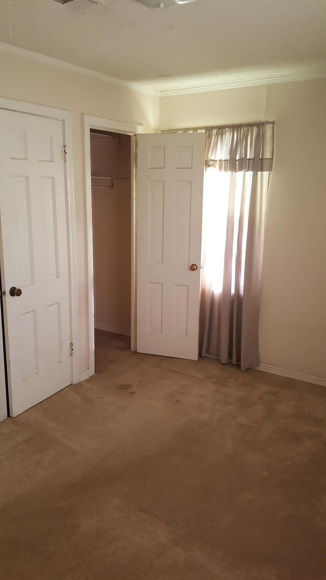 3811 South Tyler Street Amarillo, TX 79110 - Photo 7 of 10 an empty room with windows and closet