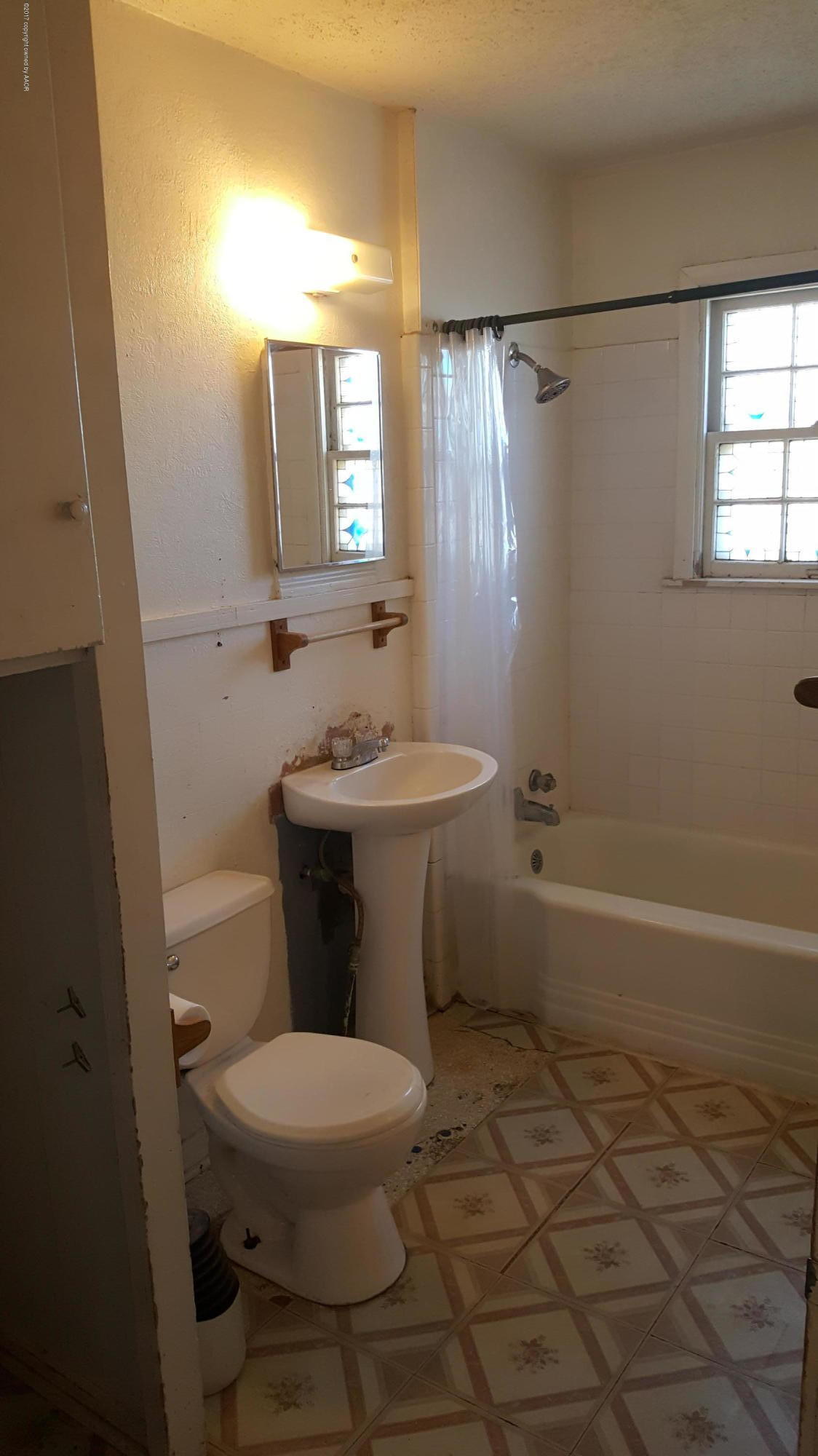 3811 South Tyler Street Amarillo, TX 79110 - Photo 9 of 10 a bathroom with a sink toilet and shower