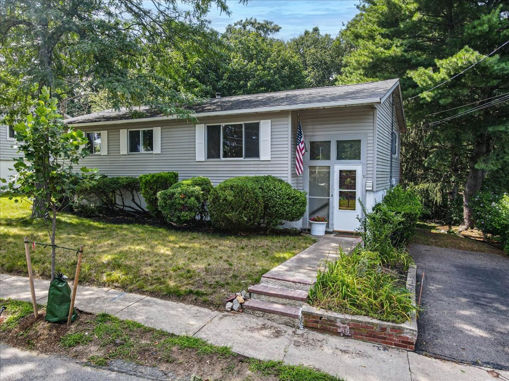 51 Joan Road Boston, MA 02136 - Photo 1 of 42 a front view of a house with garden