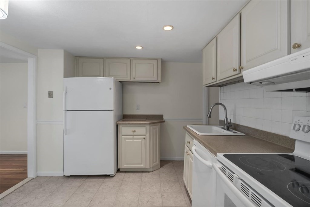 51 Joan Road Boston, MA 02136 - Photo 11 of 42 a kitchen with a sink a refrigerator and cabinets