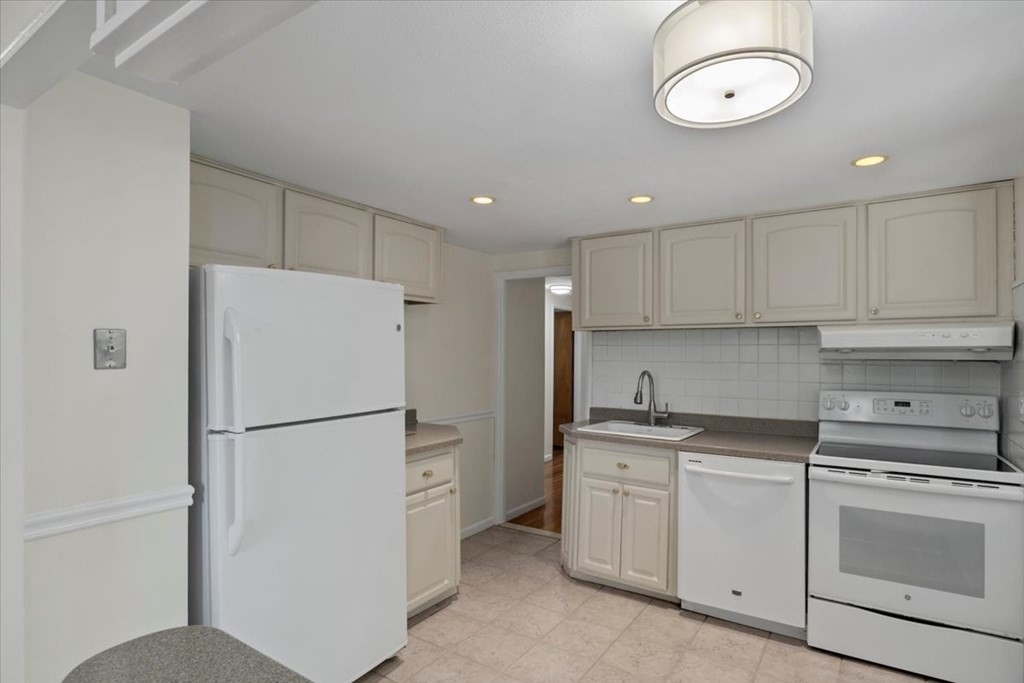 51 Joan Road Boston, MA 02136 - Photo 12 of 42 a kitchen with a refrigerator a stove and cabinets