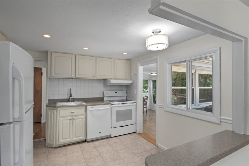 51 Joan Road Boston, MA 02136 - Photo 13 of 42 a kitchen with a stove a sink and a refrigerator