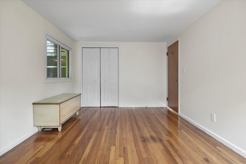 51 Joan Road Boston, MA 02136 - Photo 17 of 42 a view of an empty room with wooden floor and a window