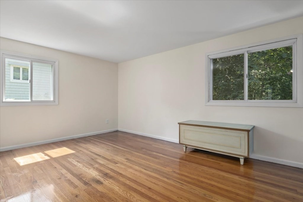 51 Joan Road Boston, MA 02136 - Photo 18 of 42 a view of an empty room with wooden floor and a window