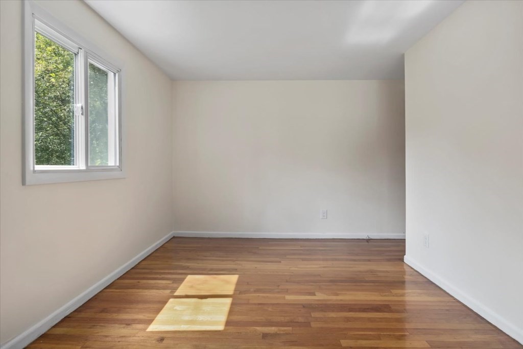 51 Joan Road Boston, MA 02136 - Photo 19 of 42 an empty room with wooden floor and windows