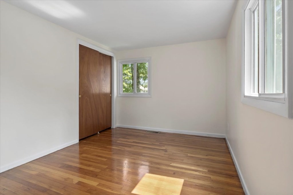 51 Joan Road Boston, MA 02136 - Photo 20 of 42 an empty room with wooden floor and windows