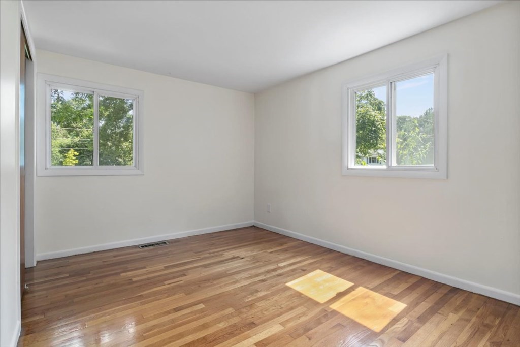 51 Joan Road Boston, MA 02136 - Photo 21 of 42 an empty room with wooden floor and windows
