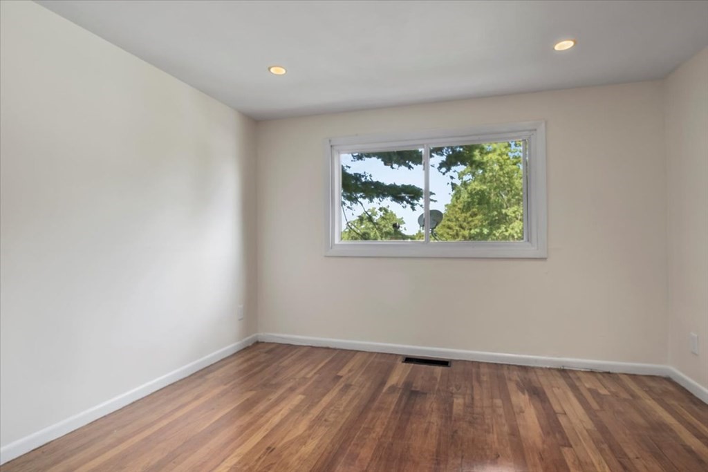 51 Joan Road Boston, MA 02136 - Photo 23 of 42 an empty room with wooden floor and windows