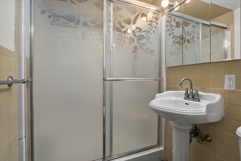 51 Joan Road Boston, MA 02136 - Photo 24 of 42 a bathroom with a sink a mirror and a shower