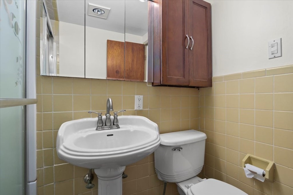 51 Joan Road Boston, MA 02136 - Photo 25 of 42 a bathroom with a toilet sink and mirror