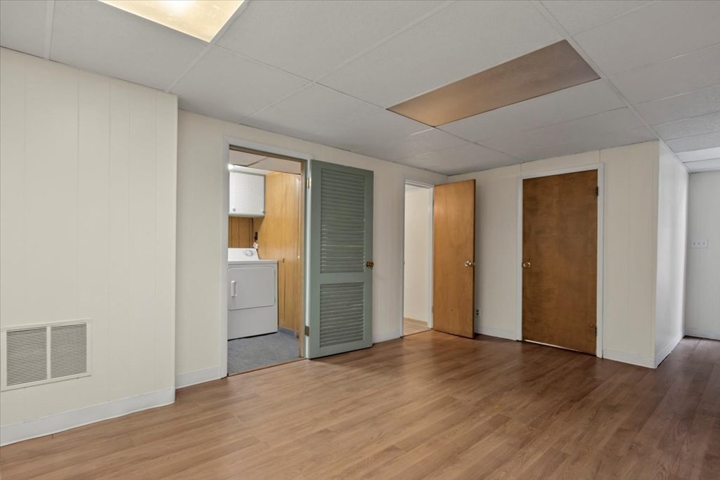 51 Joan Road Boston, MA 02136 - Photo 31 of 42 an empty room with wooden floor & windows